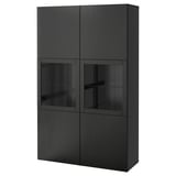Armoire BESTÅ noire avec portes vitrées pour le rangement et l’exposition. Quatre sections. Design élégant.