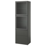 Le BESTÅ est un meuble moderne, haut et gris foncé avec trois sections : deux compartiments à porte vitrée et un tiroir inférieur pour le rangement.