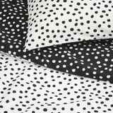 Tissu à pois noir et blanc ; motif lisse et texturé, contraste vif ; Mélange de coton de haute qualité.