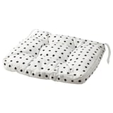 Un coussin BJÖRKTRAST à pois noirs sur fond blanc. Il est de forme carrée avec des liens à chaque coin pour un placement sûr.