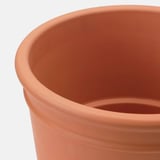 Jardinière en terre cuite, ronde, lisse, avec trou de drainage au fond.