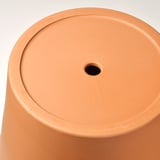 Jardinière cylindrique en terre cuite avec trou de drainage au centre.