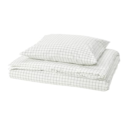 Une housse de couette DOFTAKLEJA, blanche avec motif à carreaux anthracite, en coton, rectangulaire, avec des détails cousus.