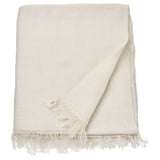 Un plaid blanc cassé DYTÅG en lin et coton, de forme rectangulaire avec des bords à franges.