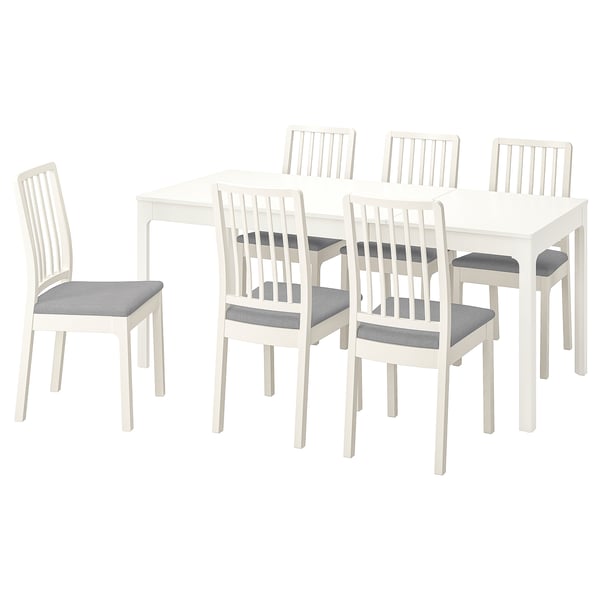 Un ensemble de salle à manger extensible EKEDALEN blanc avec six chaises rembourrées.