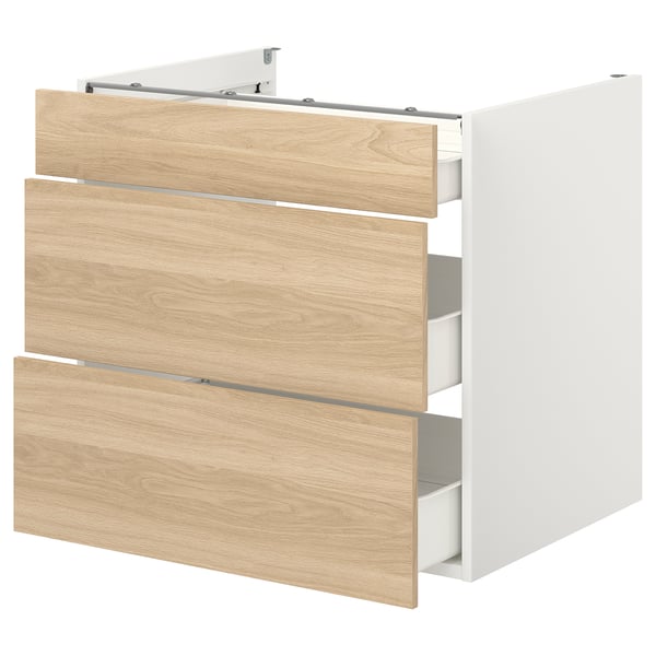 Présente une armoire de rangement ENHET avec trois tiroirs en bois. Il est blanc et a un design élégant et moderne.