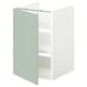 Meuble de salle de bain ENHET. Façade blanc-vert, forme carrée, design minimal. Trois étagères à l’intérieur.