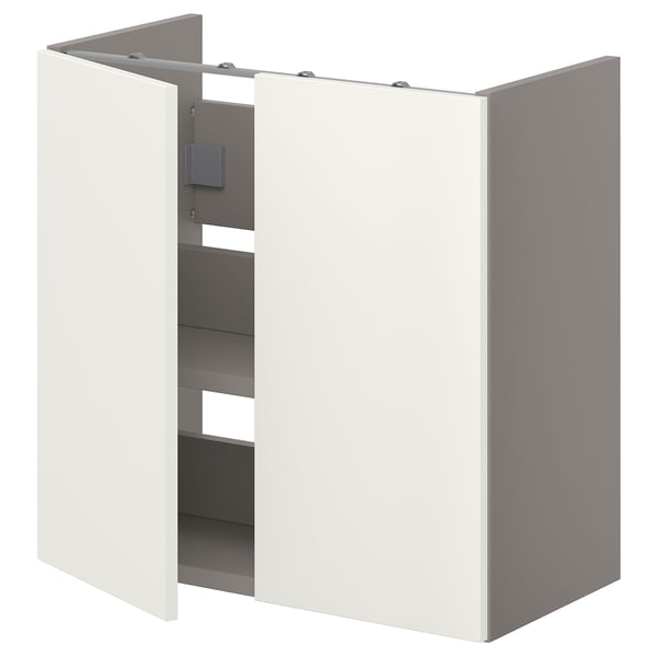 Un meuble de salle de bain ENHET blanc avec une porte ouverte, révélant des étagères à l’intérieur. Il est rectangulaire, moderne et fabriqué à partir de panneaux de particules et de plastique.