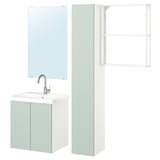 Salle de bain moderne avec armoires vert clair, comptoir blanc et miroir.