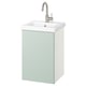 Une armoire de salle de bain murale vert pâle avec un lavabo blanc et un robinet argenté.