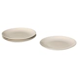Ensemble d’assiettes à manger en céramique beige unie, empilées par quatre, design simple.
