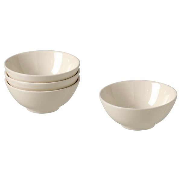 Quatre bols en céramique beige, trois empilés, un séparé, au design simple.