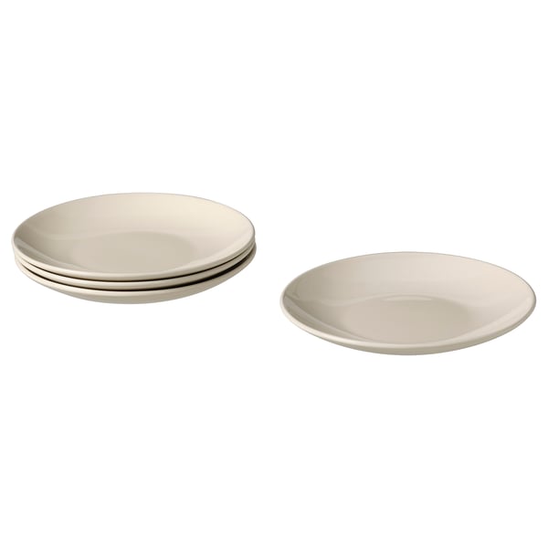 L’image montre quatre plaques latérales FÄRGKLAR beiges au design simple et rond. Deux sont empilés, deux sont séparés. Grès émaillé.