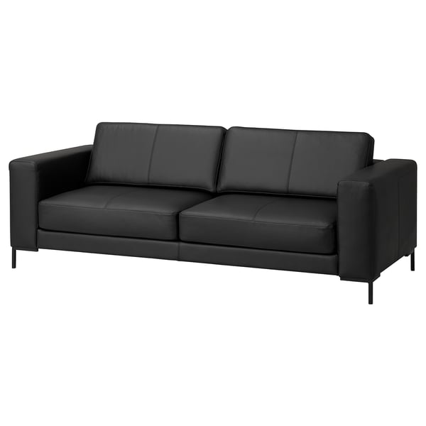 Canapé moderne en cuir noir, design minimaliste, coussins confortables.