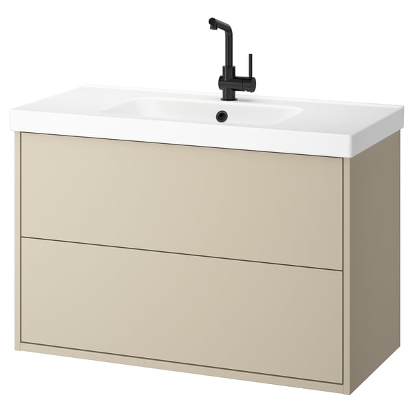 Meuble de salle de bain mural beige avec lavabo blanc et robinet noir, design minimaliste.
