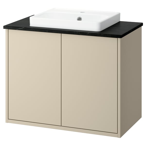 Meuble de salle de bain moderne beige avec plan de travail noir et lavabo blanc.
