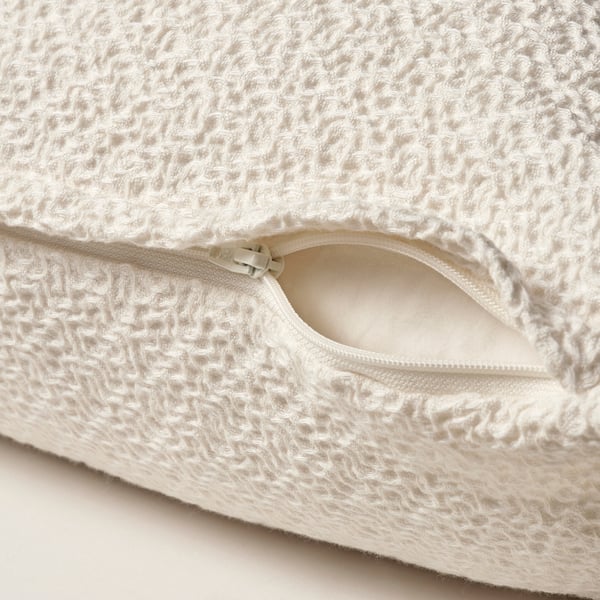 Housse de coussin tissée blanche avec fermeture éclair, coton texturé.
