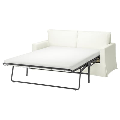 Un canapé-lit HYLTARP blanc avec un cadre en métal, des coussins rembourrés et un design moderne.