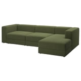 Un canapé modulaire JÄTTEBO vert olive avec une chaise longue, doté d’un revêtement en velours côtelé, de coussins moelleux et de rangements intégrés.