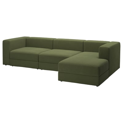Un canapé modulaire JÄTTEBO vert olive avec une chaise longue, doté d’un revêtement en velours côtelé, de coussins moelleux et de rangements intégrés.