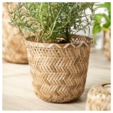 Panier à plantes en bambou tissé à la main, couleur naturelle, forme cylindrique, motif en zigzag complexe, contient une plante verte.
