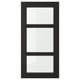 Option : Une porte d’armoire de cuisine LERHYTTAN noire avec un cadre en bois massif et des panneaux en verre transparent, mettant en valeur un design traditionnel.