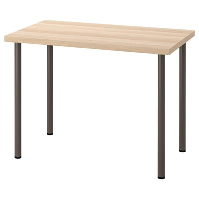 Une table LINNMON avec un plateau en bois de couleur claire et quatre pieds en métal foncé. Il est rectangulaire avec un design moderne.