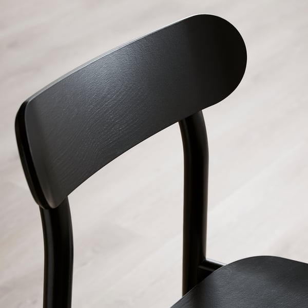 Dossier de chaise noir, design incurvé élégant. Moderne, finition lisse, cadre en bois massif robuste.