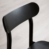 Dossier de chaise noir, design incurvé élégant. Moderne, finition lisse, cadre en bois massif robuste.