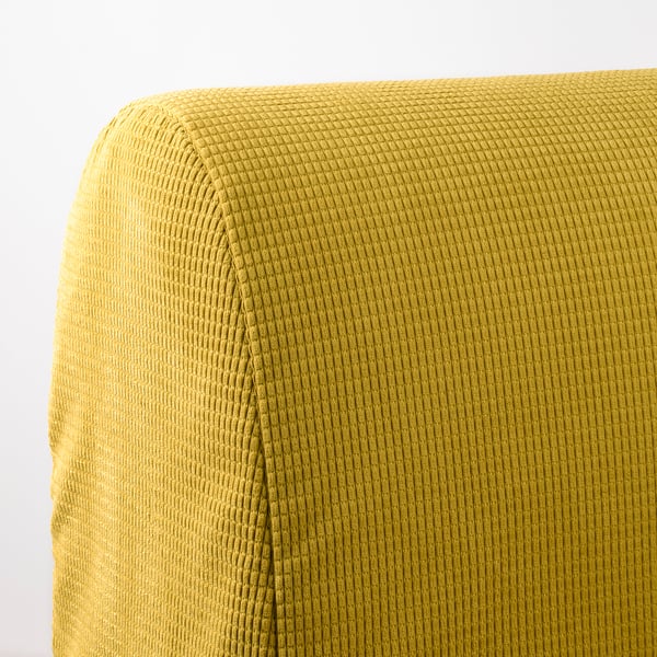 Gros plan d’un tissu de canapé texturé jaune vif, mettant en valeur son tissage complexe et son apparence douce et invitante.