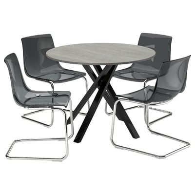 Ensemble de salle à manger rond moderne avec des chaises grises, une base de table en métal élégante et un design élégant.