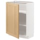 Armoire de cuisine METOD avec porte en bois clair et cadre blanc, partiellement ouverte.
