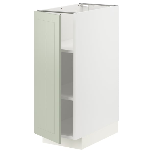 Un meuble de cuisine METOD blanc avec une porte en stensund vert. Son rectangulaire avec des étagères réglables et un design élégant et moderne.