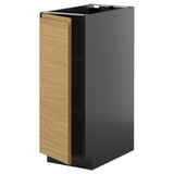 Cette image est l’armoire de cuisine METOD en noir et chêne. Le design est moderne avec des poignées minimalistes, et il s’agit d’une forme rectangulaire verticale.