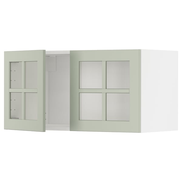 Un meuble de cuisine METOD vert avec des portes vitrées doubles, au design moderne et artisanal.