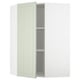 Affiche une armoire de cuisine METOD vert clair ouverte avec une porte rectangulaire simple et deux étagères intérieures.