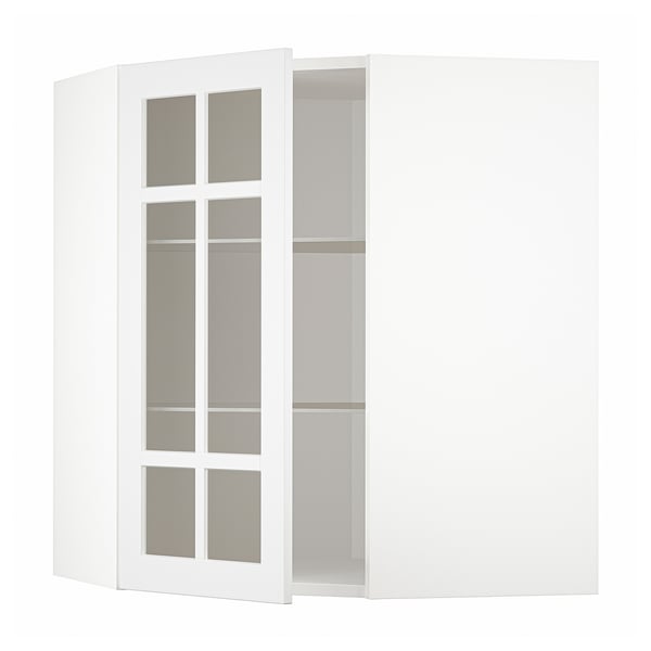 Armoire d’angle blanche avec des portes en verre dépoli montrant des étagères vides.