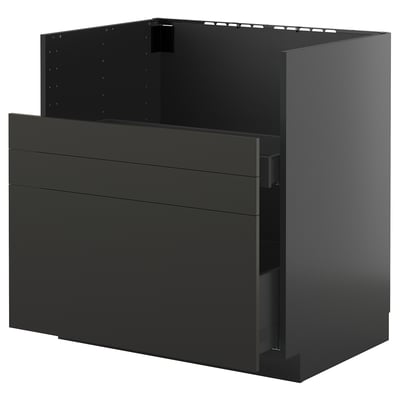 Armoire de cuisine Ikea METOD noire avec tiroirs et étagère supérieure ouverte.