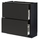 Une armoire de cuisine noire moderne du système METOD, dotée de deux tiroirs.
