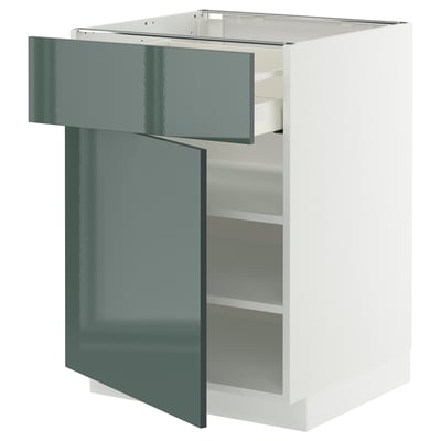 Cette image montre une armoire de cuisine METOD blanche avec un tiroir gris-vert brillant. L’armoire dispose d’une étagère réglable à l’intérieur.