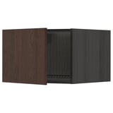 Armoire de cuisine en bois brun foncé avec porte ouverte unique, charnières métalliques.