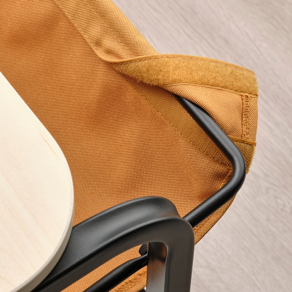 Gros plan de la pochette en tissu OLSERÖD sous la table, dotée d’une fermeture réglable pour le rangement.