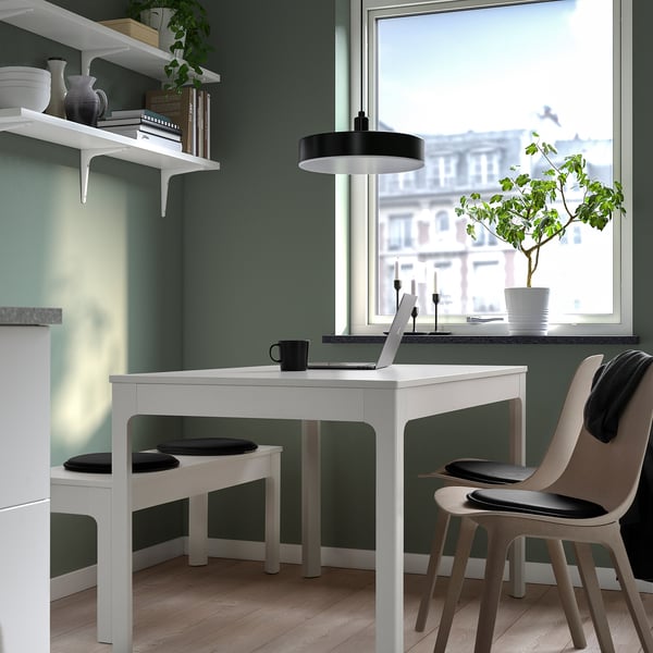Bureau à domicile avec 3 bureaux, ordinateurs portables, plantes et murs verts doux.