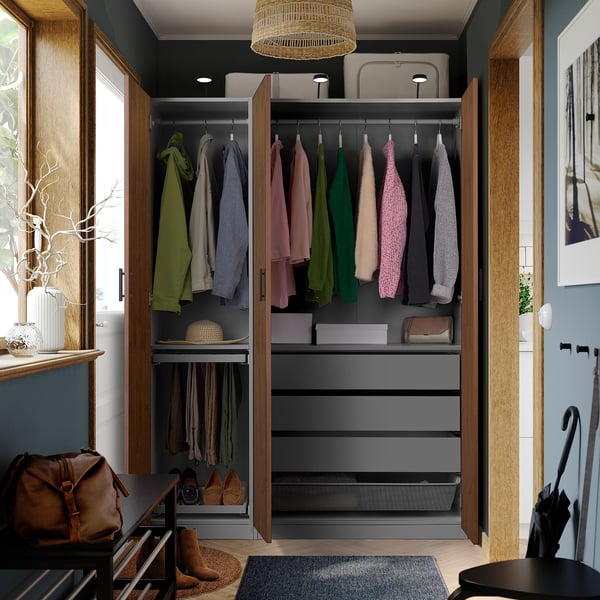 Armoire moderne avec des portes ouvertes montrant des vêtements colorés, des rangements et des accessoires.