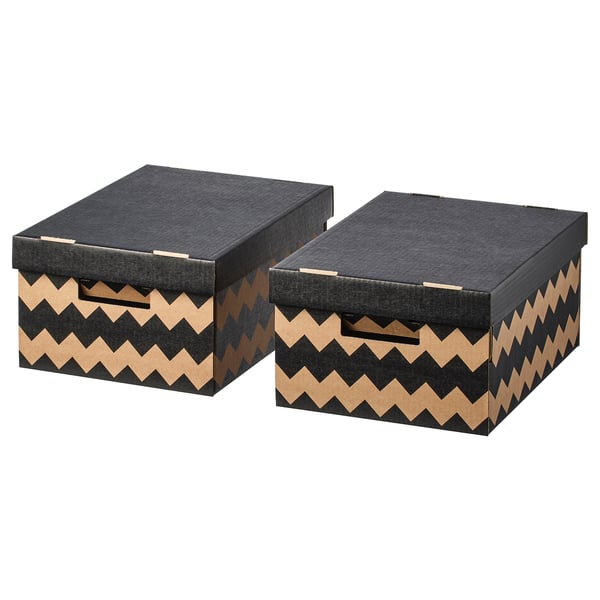 Deux boîtes de rangement noires à motif zigzag côte à côte. Robuste, avec poignées découpées.
