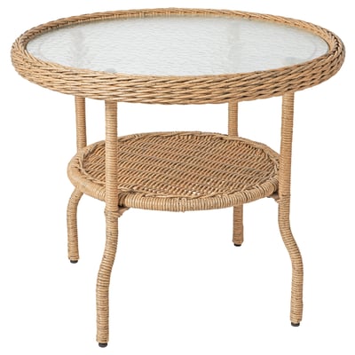 Table d’appoint RISHOLMEN : plateau en verre beige, osier et transparent, ronds, pieds ondulés, résistant aux intempéries.