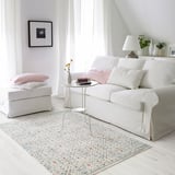 Tapis floral ROMDRUP dans le salon avec canapé, ordinateur portable, vase.