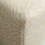 Gros plan d’un coin d’un coussin à motifs, mettant en valeur ses coutures détaillées et la qualité du tissu.