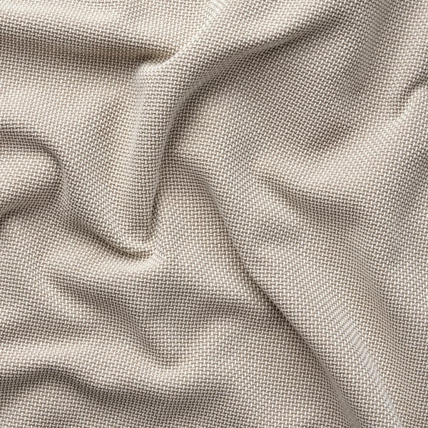 Gros plan d’un tissu beige tissé, texturé, produit de manière durable.