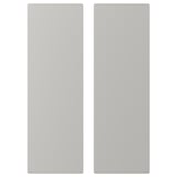 Deux panneaux gris clair, rectangulaires, aux bords légèrement arrondis, l’un légèrement décalé par rapport à l’autre.